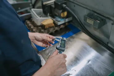 Quality control measurement with digital calipers — Baked Industries